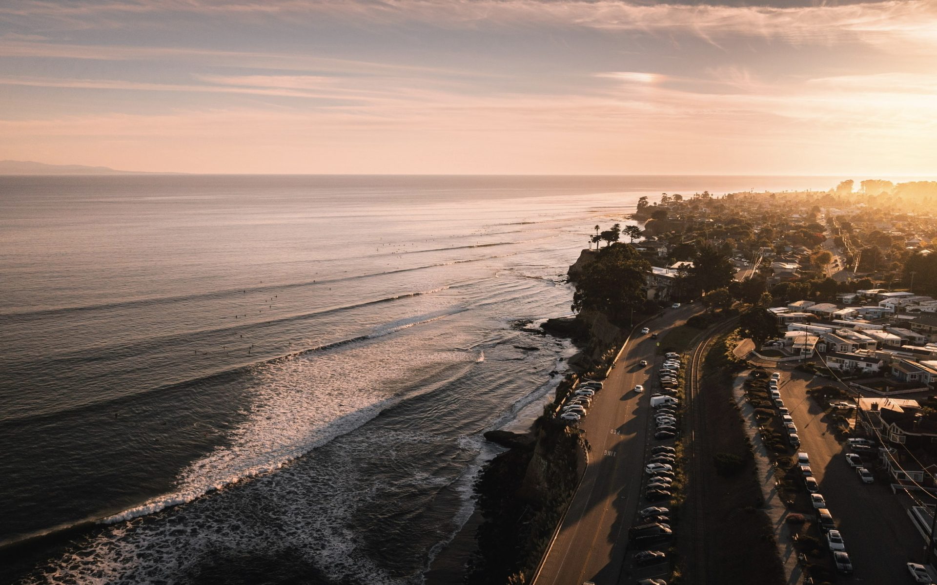 Aerial view of a coastline glowing at sunset